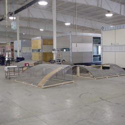 Pre-site factory construction of modular buildings