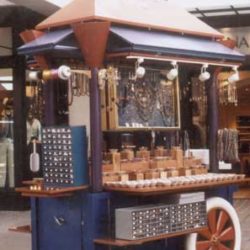 Custom retail cart with metal security at outdoor shopping center